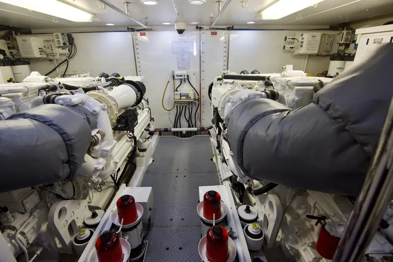 T.t. Amore Yacht Photos Pics Engine room of 2004 West Bay Cockpit Pilot House Motoryacht, featuring dual engines and equipment.