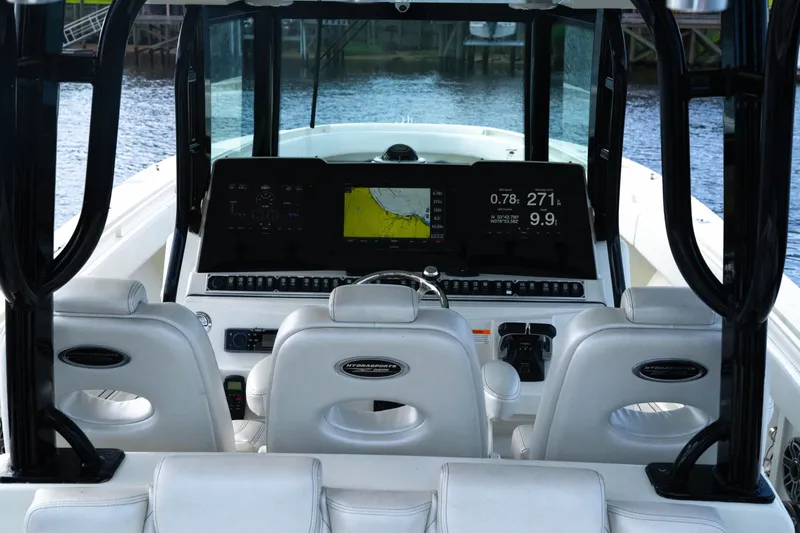  Yacht Photos Pics 2018 Hydra-Sports 3900 Speciale boat cockpit with advanced navigation system and white seating.