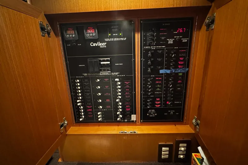 Hammertime Yacht Photos Pics Electrical panel of a 2002 Cavileer 48 Flybridge Sportfish yacht, featuring various switches and gauges.