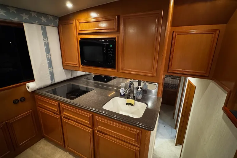 Hammertime Yacht Photos Pics Luxurious kitchen interior of 2002 Cavileer 48 Flybridge Sportfish yacht.