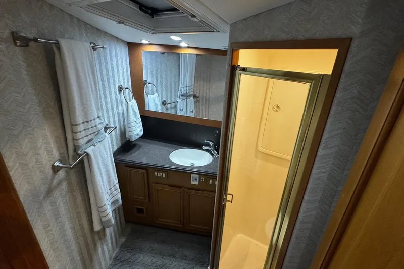 Hammertime Yacht Photos Pics Bathroom interior of 2002 Cavileer 48 Flybridge Sportfish yacht with sink and shower.