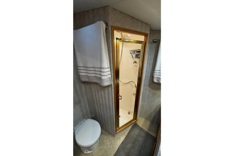 Hammertime Yacht Photos Pics Bathroom interior of 2002 Cavileer 48 Flybridge Sportfish with shower and toilet.