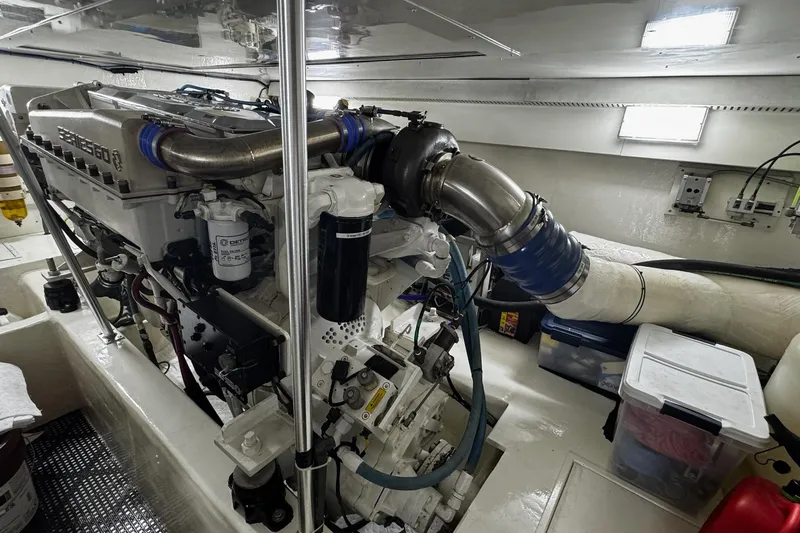Hammertime Yacht Photos Pics Engine room of 2002 Cavileer 48 Flybridge Sportfish, showcasing a powerful marine engine.