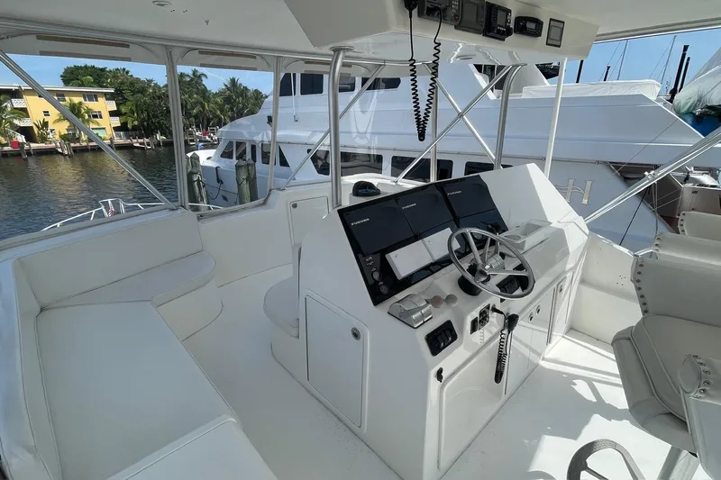 Hammertime Yacht Photos Pics 2002 Cavileer 48 Flybridge Sportfish helm with modern controls and seating, docked by waterfront.