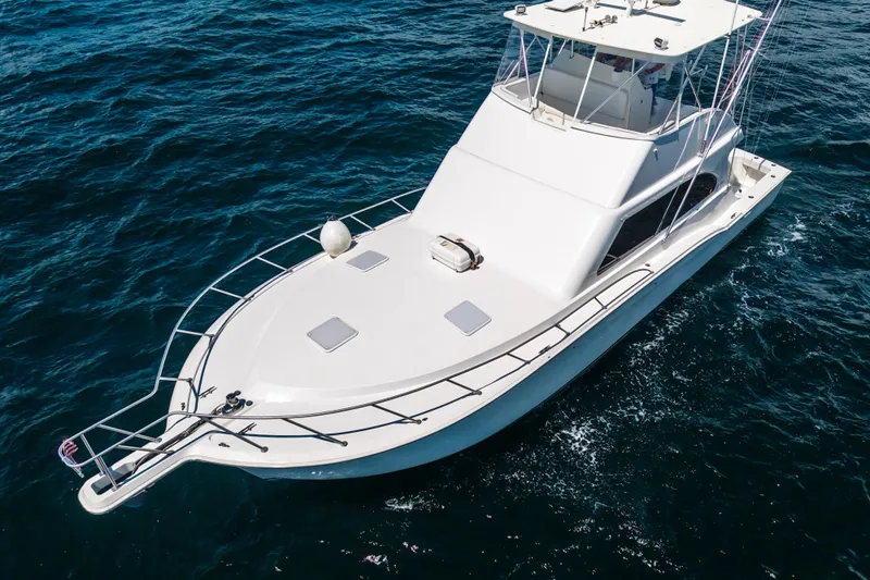 Hammertime Yacht Photos Pics 2002 Cavileer 48 Flybridge Sportfish yacht cruising on open water.