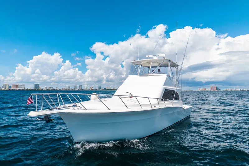 Hammertime Yacht Photos Pics 2002 Cavileer 48 Flybridge Sportfish yacht cruising on open water under blue skies.