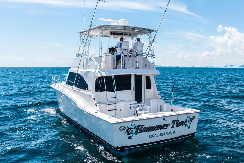 Hammertime Yacht Photos Pics Cavileer 48 Flybridge Sportfish 2002 cruising on open sea under clear blue sky.
