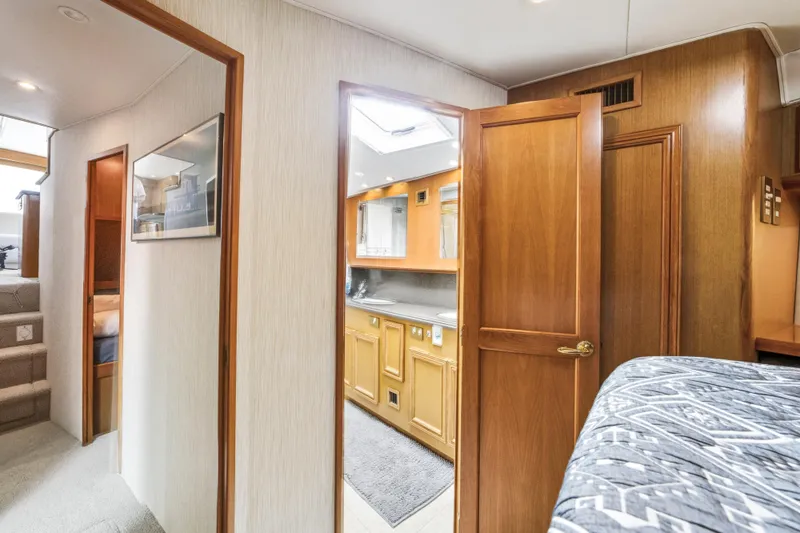 Hammertime Yacht Photos Pics Interior of 2002 Cavileer 48 Flybridge Sportfish with wood finishes and cozy design.