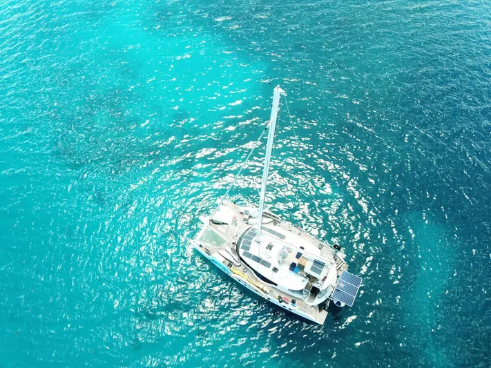Chasing Waterfalls Yacht Photos Pics Aerial view of 2014 Tayana Isara 50 yacht on clear turquoise water.