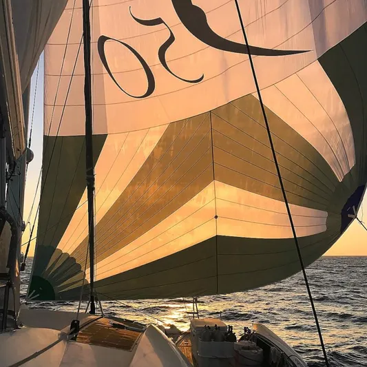 Chasing Waterfalls Yacht Photos Pics Sailing yacht Tayana Isara 50 with sunlit sails at sea, 2014 model.