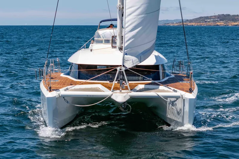 Chasing Waterfalls Yacht Photos Pics 2014 Tayana Isara 50 catamaran sailing on open sea, front view.