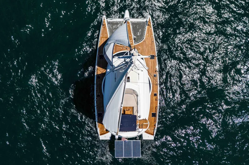 Chasing Waterfalls Yacht Photos Pics Aerial view of 2014 Tayana Isara 50 sailboat on shimmering water.