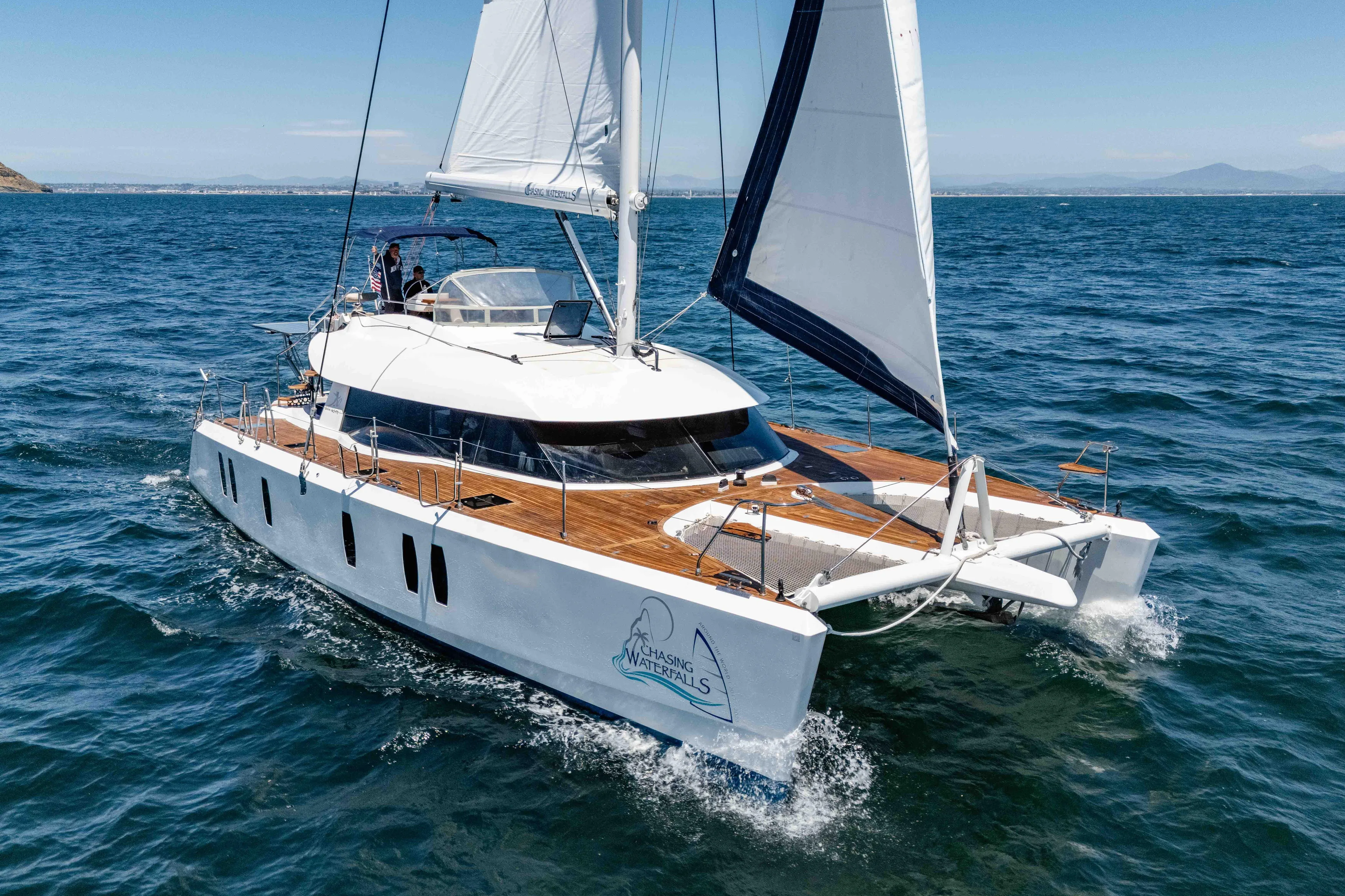 Chasing Waterfalls Yacht Photos Pics Sailing catamaran Tayana Isara 50, 2014 model, cruising on open sea under clear skies.