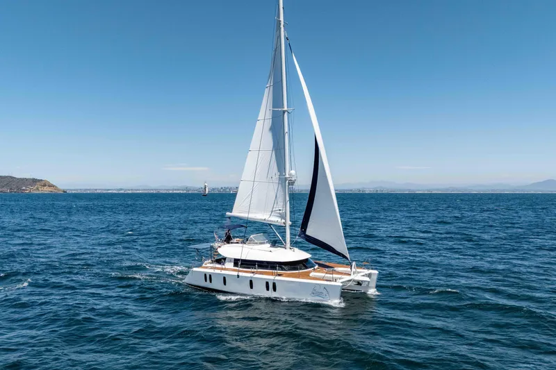 Chasing Waterfalls Yacht Photos Pics Sailing yacht Tayana Isara 50, 2014 model, cruising on open sea under clear blue sky.