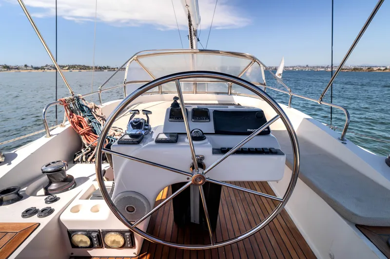 Chasing Waterfalls Yacht Photos Pics Tayana Isara 50 sailboat cockpit with steering wheel, ocean view, and navigation equipment, 2014 model.
