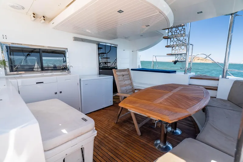 Chasing Waterfalls Yacht Photos Pics Spacious deck of 2014 Tayana Isara 50 yacht with wooden table and ocean view.