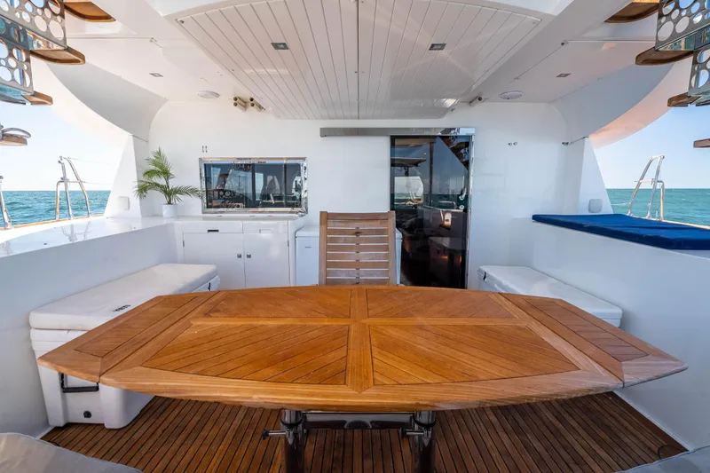 Chasing Waterfalls Yacht Photos Pics Luxurious 2014 Tayana Isara 50 yacht interior with wooden table and ocean view.