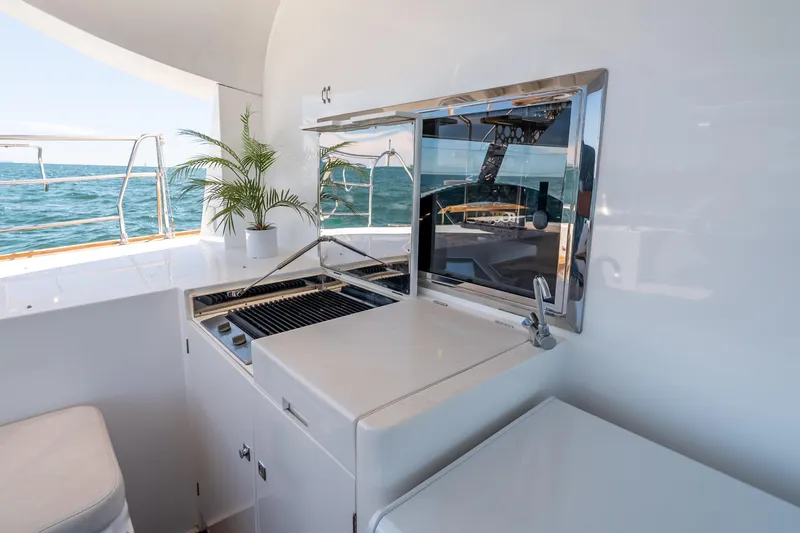 Chasing Waterfalls Yacht Photos Pics Outdoor kitchen on 2014 Tayana Isara 50 yacht with ocean view and potted plant.