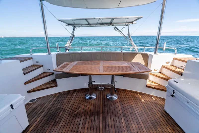 Chasing Waterfalls Yacht Photos Pics Luxurious 2014 Tayana Isara 50 yacht deck with wooden table and ocean view.