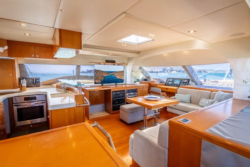 Chasing Waterfalls Yacht Photos Pics Luxurious interior of 2014 Tayana Isara 50 yacht with modern kitchen and seating area.