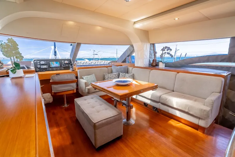 Chasing Waterfalls Yacht Photos Pics Luxurious interior of 2014 Tayana Isara 50 yacht with plush seating and elegant wood finishes.