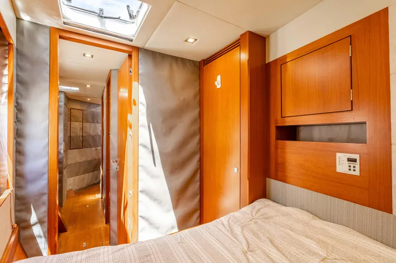 Chasing Waterfalls Yacht Photos Pics Luxurious 2014 Tayana Isara 50 yacht interior with wood paneling and cozy bedroom.