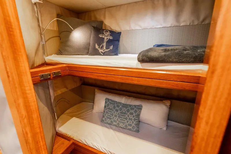 Chasing Waterfalls Yacht Photos Pics Cozy bunk beds in 2014 Tayana Isara 50 yacht cabin with nautical-themed decor.