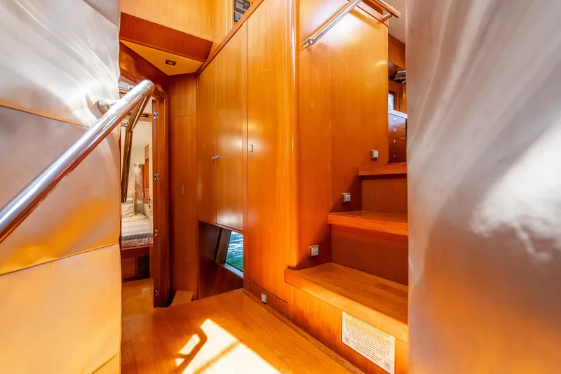 Chasing Waterfalls Yacht Photos Pics Luxurious wooden interior of 2014 Tayana Isara 50 yacht with stairs and cabin view.