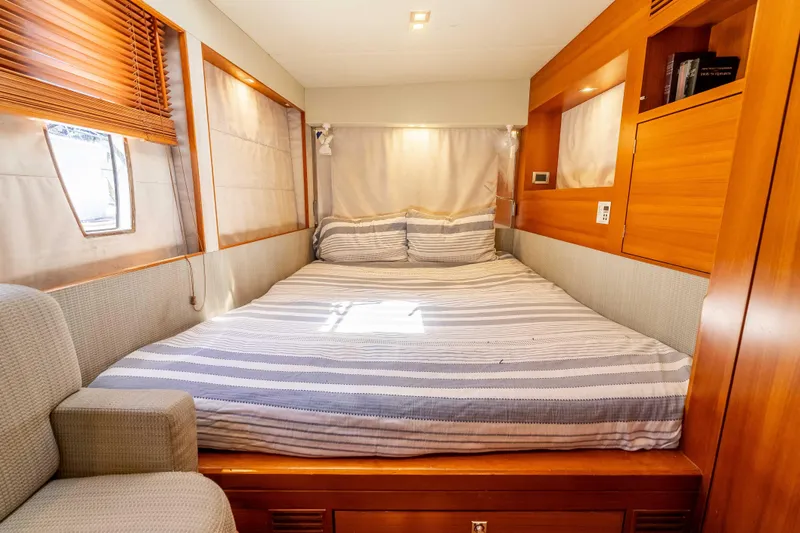Chasing Waterfalls Yacht Photos Pics Luxurious cabin interior of 2014 Tayana Isara 50 yacht with cozy bed and wooden accents.