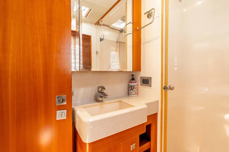 Chasing Waterfalls Yacht Photos Pics Luxurious bathroom interior of 2014 Tayana Isara 50 yacht with wooden accents and modern fixtures.