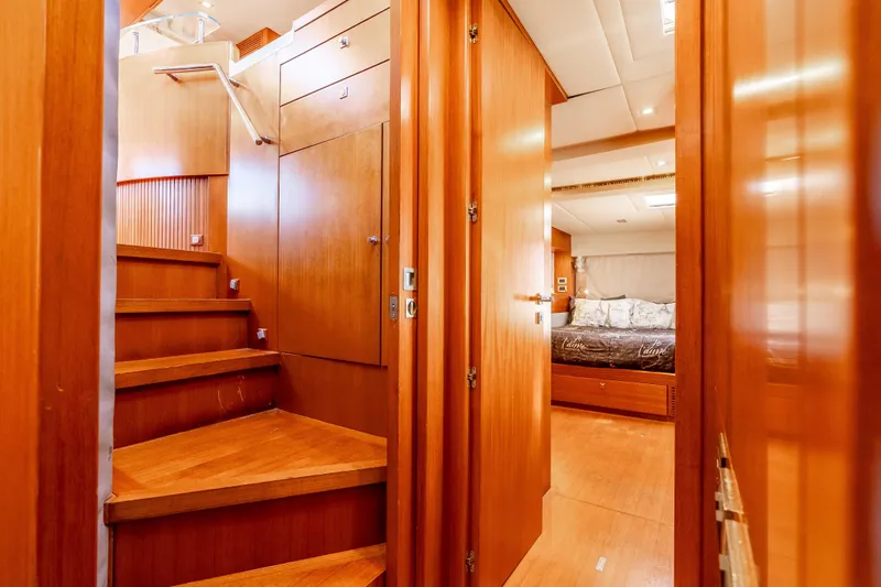 Chasing Waterfalls Yacht Photos Pics Interior of 2014 Tayana Isara 50 yacht with wooden stairs and cozy bedroom.