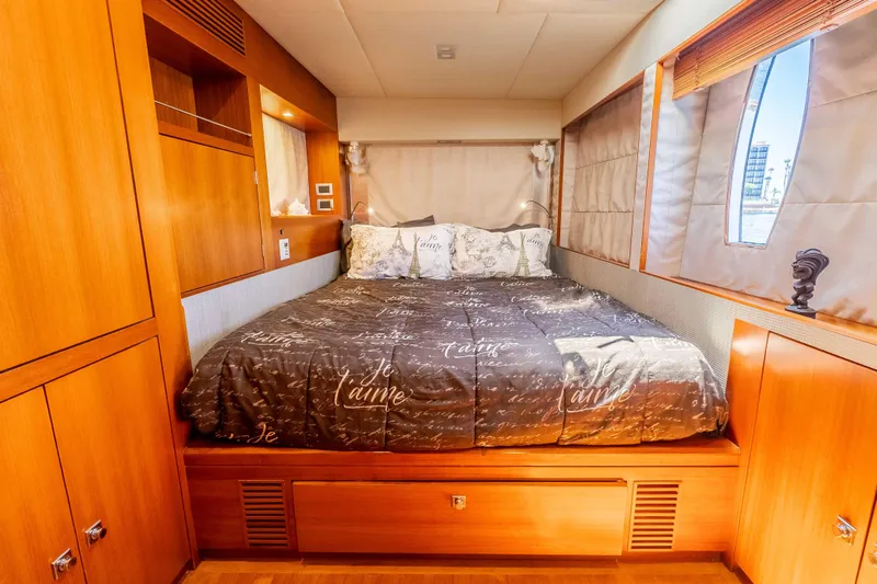 Chasing Waterfalls Yacht Photos Pics Luxurious cabin interior of 2014 Tayana Isara 50 yacht with cozy bedding and wooden finishes.