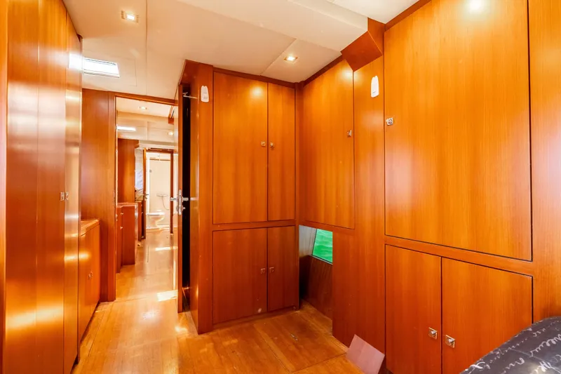 Chasing Waterfalls Yacht Photos Pics Luxurious wooden interior of 2014 Tayana Isara 50 yacht, featuring ample storage and elegant design.