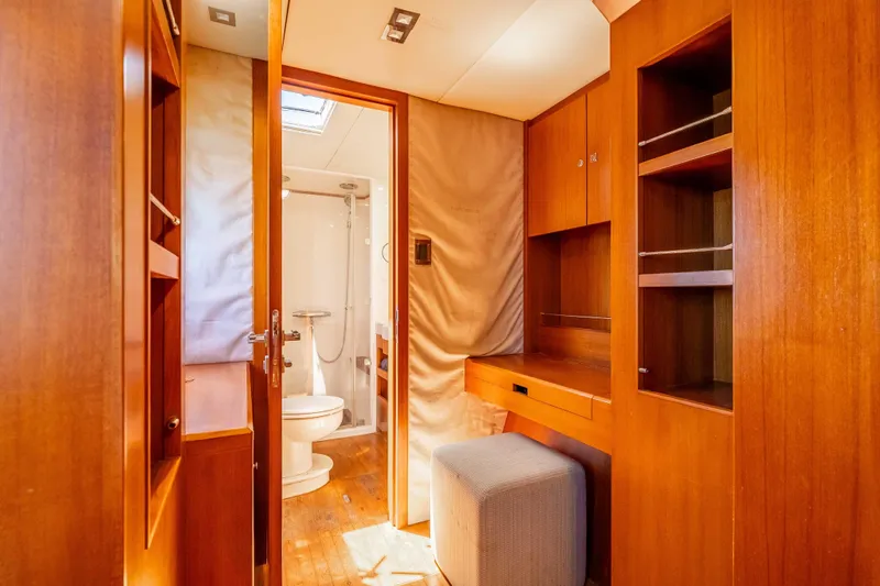 Chasing Waterfalls Yacht Photos Pics Luxurious 2014 Tayana Isara 50 yacht interior with wooden cabinetry and bathroom.
