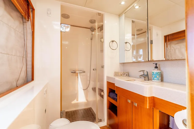Chasing Waterfalls Yacht Photos Pics Luxurious bathroom in 2014 Tayana Isara 50 yacht with modern fixtures and wooden accents.