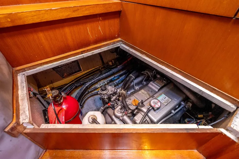 Chasing Waterfalls Yacht Photos Pics Engine compartment of 2014 Tayana Isara 50 yacht, featuring a fire extinguisher and mechanical components.