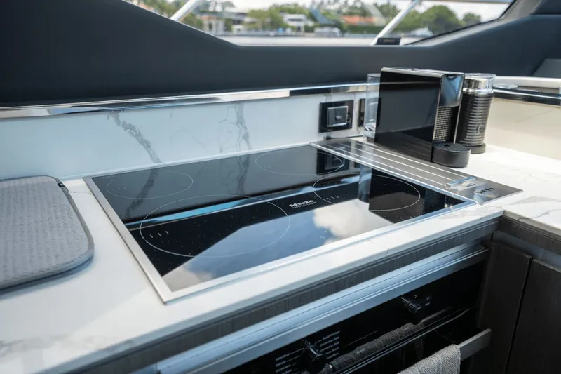 Hard To Get Yacht Photos Pics Modern kitchen in 2019 Azimut S7 yacht with sleek induction cooktop and espresso machine.