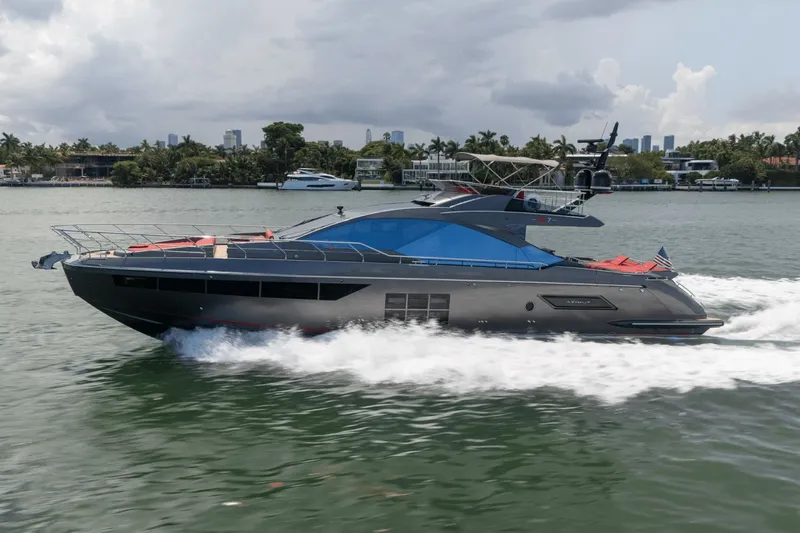 Hard To Get Yacht Photos Pics 2019 Azimut S7 yacht cruising on a scenic waterway with city skyline backdrop.