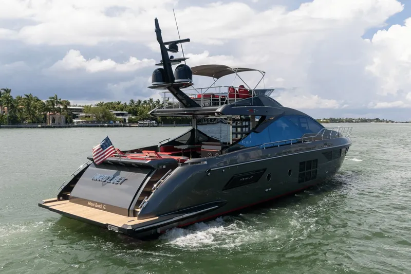 Hard To Get Yacht Photos Pics 2019 Azimut S7 yacht cruising on a scenic waterway under a cloudy sky.