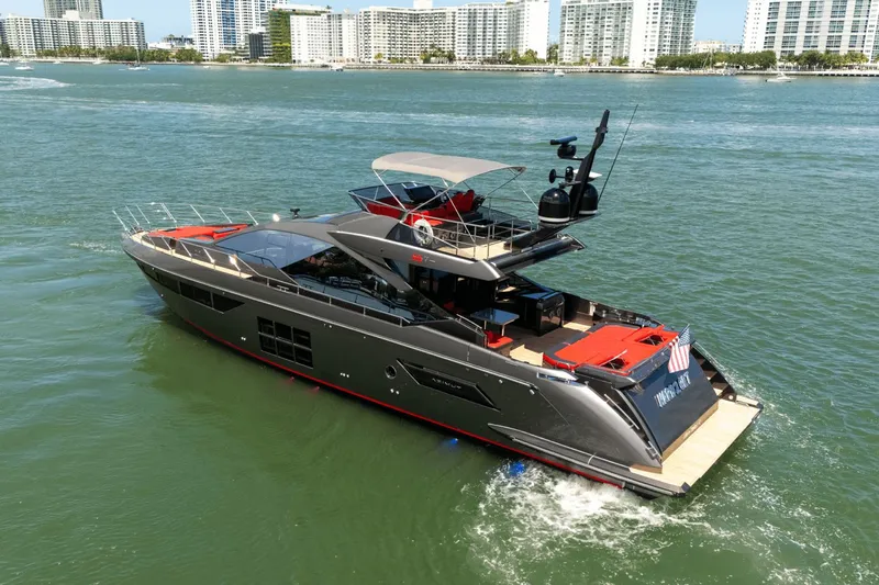 Hard To Get Yacht Photos Pics 2019 Azimut S7 yacht cruising in a coastal cityscape, featuring sleek design and luxury amenities.