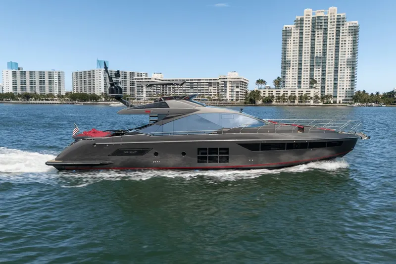 Hard To Get Yacht Photos Pics 2019 Azimut S7 yacht cruising on water with city skyline in background.