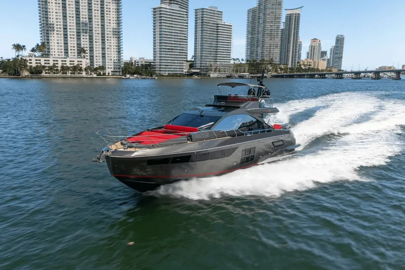 Hard To Get Yacht Photos Pics 2019 Azimut S7 yacht cruising near city skyline, creating a dynamic water trail.
