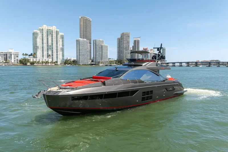 Hard To Get Yacht Photos Pics 2019 Azimut S7 yacht cruising near city skyline on a sunny day.