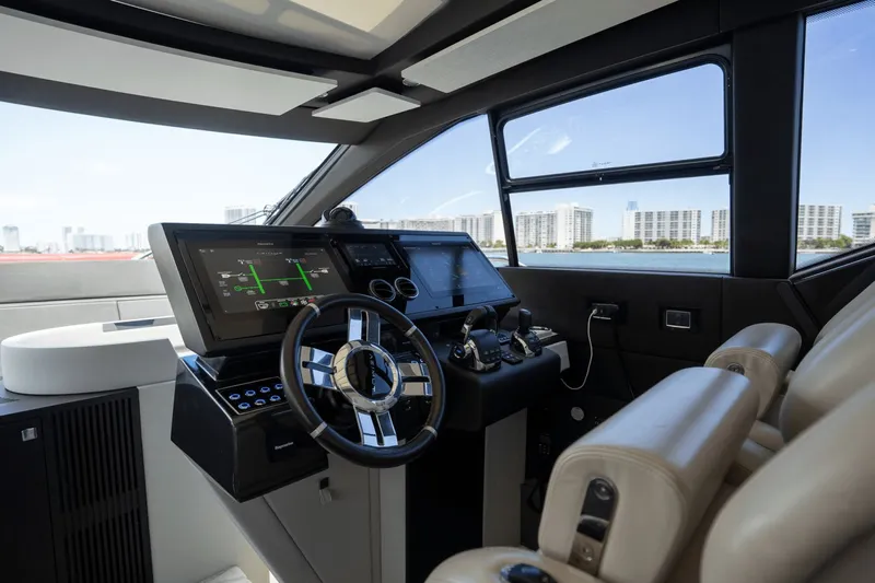 Hard To Get Yacht Photos Pics Interior cockpit of 2019 Azimut S7 yacht with modern steering and navigation systems.