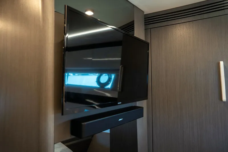 Hard To Get Yacht Photos Pics Flat-screen TV in 2019 Azimut S7 yacht interior with modern wood paneling.