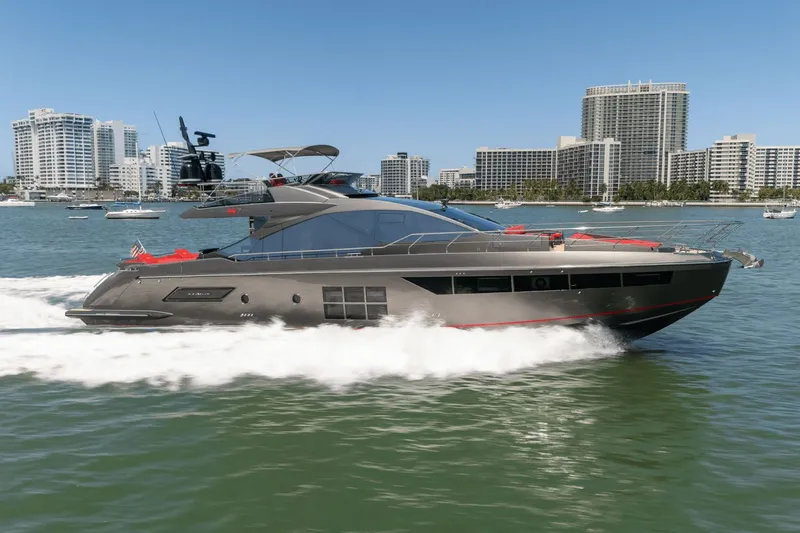Hard To Get Yacht Photos Pics 2019 Azimut S7 yacht cruising in a city harbor with modern buildings in the background.