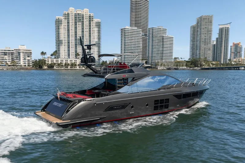 Hard To Get Yacht Photos Pics 2019 Azimut S7 yacht cruising near city skyline, modern luxury vessel on water.