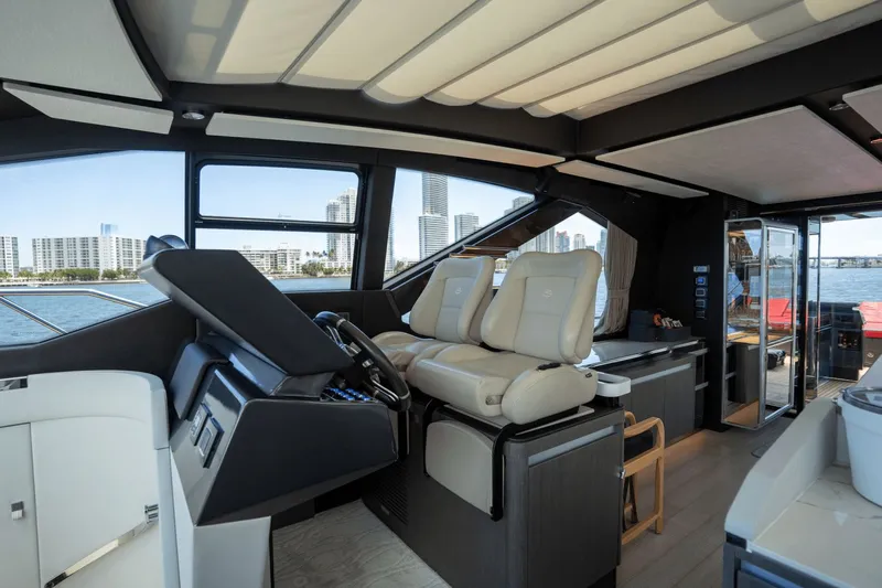Hard To Get Yacht Photos Pics Luxurious interior of 2019 Azimut S7 yacht with modern helm and cityscape view.