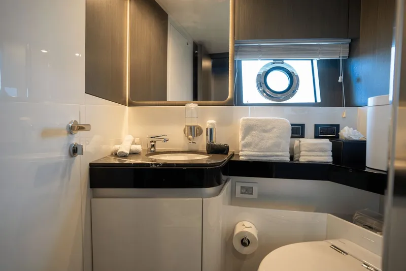 Hard To Get Yacht Photos Pics Luxurious bathroom in 2019 Azimut S7 yacht with modern fixtures and porthole window.