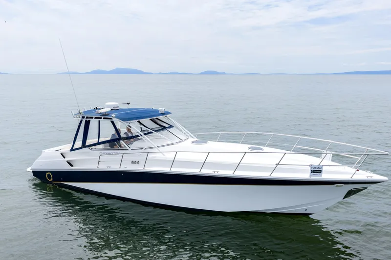  Yacht Photos Pics 2008 Fountain 38 Sportfish Cruiser on calm water, side view.